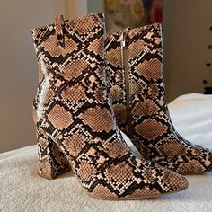 This Is A Pair Of Faux Leather Ankle Boots Featuring A Snakeskin Print, A Pointed Toe, Side Zipper, And A High Block Heel. These Are A Size Eur 39/Us 8. More Specifics: Leg Circumference: 10.8 Inch Shaft Height:6 Inch Heel Height:3.9 Inch Pair These Booties With A Little Black Dress And Duster Jacket, And You’re Set To-Go! You’ll Look Great. These Boots Are Brand New, They Have Never Been Worn. Fall Snake Print Ankle Boots, Trendy Brown Faux Leather Mid-calf Boots, Brown Synthetic Heeled Boots For Fall, Brown Synthetic Heeled Boots For Winter, Fall Brown Synthetic Heeled Boots, Snake Print Heeled Boots With Round Toe For Fall, Fall Round Toe Heeled Boots With Snake Print, Brown Snake Print Ankle Boots, Fall Snake Print Round Toe Heeled Boots