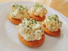 small appetizers are arranged on a white plate