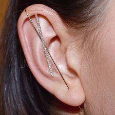 a close up of a person's ear with a pair of piercings on it