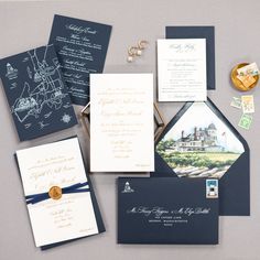 the wedding stationery is laid out on top of each other, including two envelopes