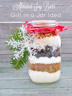 a mason jar filled with cookies, nuts and other things to make it look like christmas