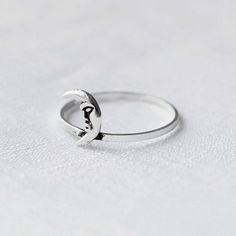 Real 925 Sterling Silver Crescent Moon Ring Ring Face Measures 8.50 x 6mm Ring Band Thickness measures 1mm Jewelry will come in a gift box * Please read shop policy before placing an order * *JEWELRY CARE* Sterling Silver will tarnish over time, but to help keep your jewelry looking beautiful - Clean with a soft dry cloth after wear and store inside an airtight bag or container. Remember to remove your jewelry when: * Applying lotion or sunscreen * Applying perfume * Taking a shower / bath * Wor Adjustable Moon Shaped Promise Ring, Minimalist Adjustable Moon Phase Rings, Minimalist Moon Phase Rings For Anniversary, Dainty Moon-shaped Midi Promise Rings, Minimalist Adjustable Rings With Moon Charm, Adjustable Moon Shaped Symbolic Rings, Minimalist Adjustable Ring With Moon Charm, Sterling Silver Moon Phase Promise Ring, Silver Moon Shaped Celestial Ring