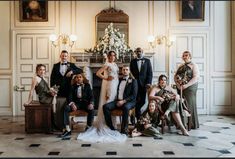 a group of people in formal wear posing for a photo