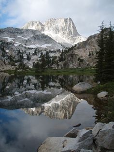 the mountain is reflected in the still water