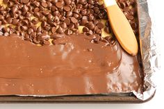 a cake with chocolate frosting and sprinkles is on a baking sheet