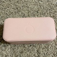 a pink case sitting on top of a carpet