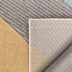 carpet samples with different colors and patterns on the floor, including beige, blue, grey and white