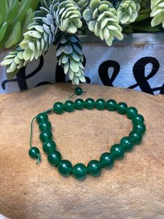 "Beaded bracelet using Green Jade natural stone beads on a nylon cord. Adjustable from 7\"-9\". Your choice of 6mm or 8mm beads. 6mm beads are a darker shade of green, see photos!! Green Jade the \"Royal Gemstone\". The sacred stone is considered a sign of luck and good fortune. It is also associated with abundance, wealth and prosperity. This powerful gemstone can bring wisdom, balance, calm and peace to the wearer!!" Adjustable Green Beaded Bracelet Spiritual, Adjustable Green Beaded Spiritual Bracelets, Adjustable Jade Beaded Bracelet For Healing, Adjustable Stretch Bracelet With Round Beads For Healing, Green Gemstone Beaded Bracelets For Meditation, Adjustable Rosary Bracelet For Healing With 108 Beads, Green Beaded Bracelets For Meditation, Green Stretch Bracelet For Meditation, Adjustable Green Beaded Bracelet