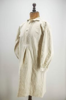 "Antique French worker shirt, peasant natural homespun hemp coverall shirt / dress, antique French smock, grey mop buttons, red monogram MEASURES: 38 1/4\" (97.2 cm) length, the sleeves are 20\" (40.8 cm) long, circa 20 1/4\" (51.4 cm) chest width. DESCRIPTION: Stunning young men's shirt / chemise, traditionally worn by French peasants and workers, dating to the late 1800's. This antique shirt coverall is made from natural color homespun hemp or linen, there is a red hand-embroidered monogram JV 1800s Men, Mop Buttons, 1800s Fashion, Shirt Making, Sweeney Todd, Embroidered Monogram, Antique Fabrics, Historical Clothing, Vintage Tops