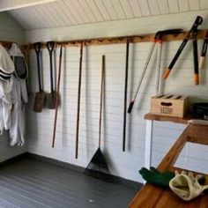 a room filled with lots of different types of tools on the wall and hanging from hooks