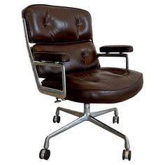 a brown leather office chair with wheels and footrests on an isolated white background