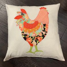 a decorative pillow with a rooster on it