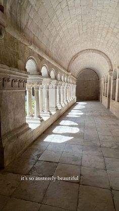 the inside of a stone tunnel with columns and arches