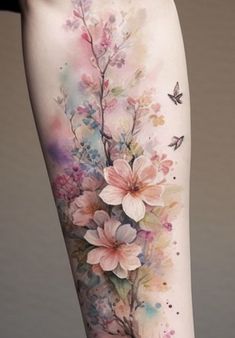 a woman's leg with flowers and butterflies on it, painted in watercolor