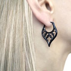 This gothic hoop earrings with cathedral design elements is a captivating piece of jewelry that combines the elegance of a hoop earring with the intricate beauty of Gothic architecture. Its stainless steel construction ensures durability, while its unique design adds a touch of dark sophistication to any ensemble. Sold as pair of hoops Material : 316 Stainless steel Hoop inner diameter: 13 mm Hoop length: 35 mm (edge to edge) Hoop width :23mm Ships in a gift box Listing for hoop earrings only Cathedral Earrings, Cathedral Design, Earrings Gothic, Steampunk Earrings, Unisex Earrings, Jewelry Gothic, Pvd Coating, Gothic Earrings, Earrings Hoop