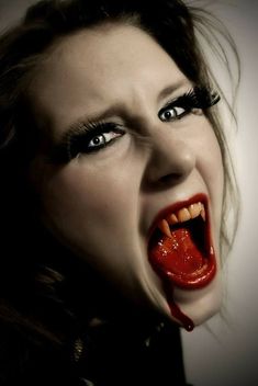 a woman with her mouth open and blood dripping down the side of her face,