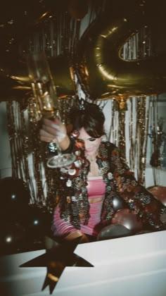 a woman in a bathtub with balloons and streamers