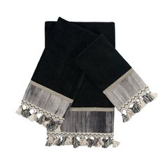 two black towels with tassels on top of each one and the other side