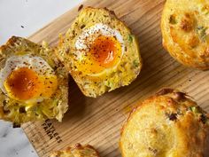 some eggs are sitting on top of muffins