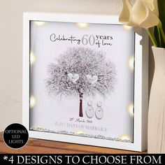 a white frame with a tree on it and the words celebrating 60 years of love