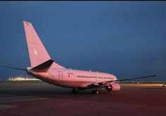 an airplane is sitting on the runway at night