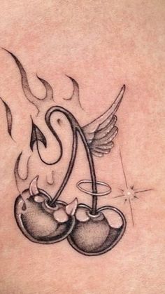 a tattoo with two cherries on the chest and an angel above it, flying through the air