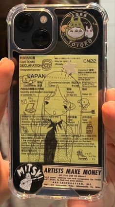 a person holding up a cell phone case