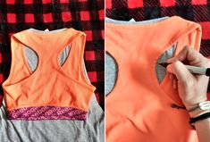 a woman's hand is writing on the back of an orange sports bra top