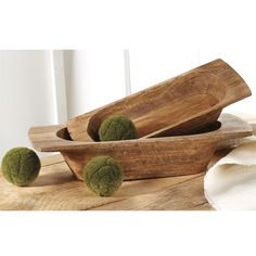 three wooden bowls with green balls in them