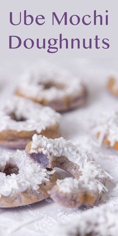 there are several doughnuts with white frosting on them and the words, ube mochi doughnuts