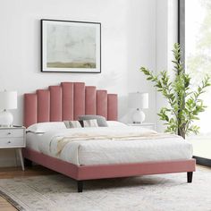 a bed with pink headboard and foot board in a white room next to a large window