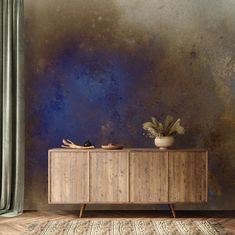 a sideboard with two bowls on it in front of a blue and brown wall