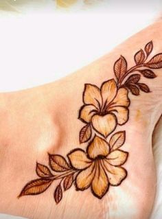 a flower tattoo is shown on the foot