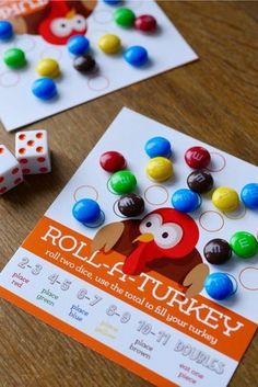 two game cards and dices on a table with the words roll - a - turkey