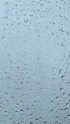 raindrops on the window with blue sky in the backgroung background