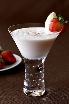 a banana split martini is garnished with strawberries