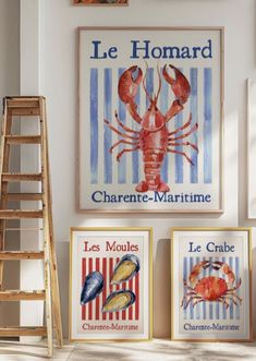 three framed lobsters are on the wall next to two ladders and one has a sign that says le homard