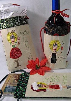 two wine bags with designs on them are next to a book and some other items