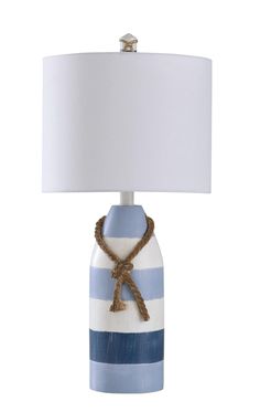 a blue and white striped lamp with a white shade