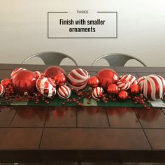 a table with red and white ornaments on it that says finish with smaller ornaments ornaments