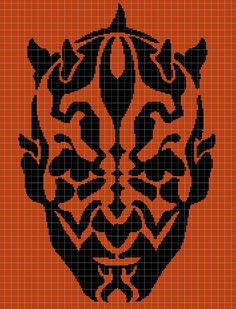 an orange and black cross - stitch pattern with the shape of a lion's head