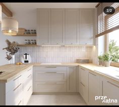 a kitchen with white cabinets and wooden counter tops