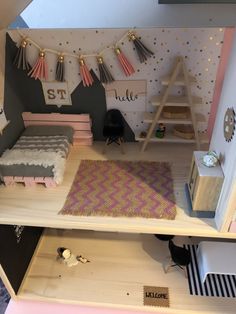 a doll house with furniture and accessories on the shelves, including a bed, desk, chair, rugs and other items