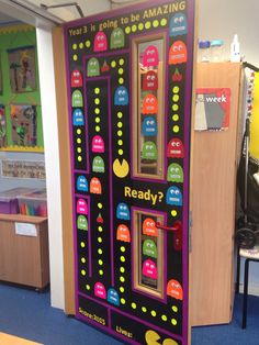 the door to an interactive learning area is decorated with stickers