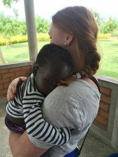 a woman holding a child in her arms