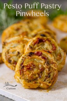 three puff pastry pinwheels sitting on top of a cutting board with text overlay