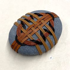 a rock with some sort of woven design on it