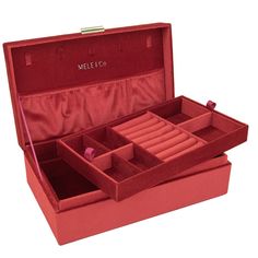 an open red jewelry box with compartments on the top and bottom, sitting in front of a white background