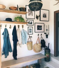 there is a coat rack on the wall with hats and purses hanging from it