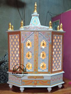 an elaborately painted cabinet with bells on it